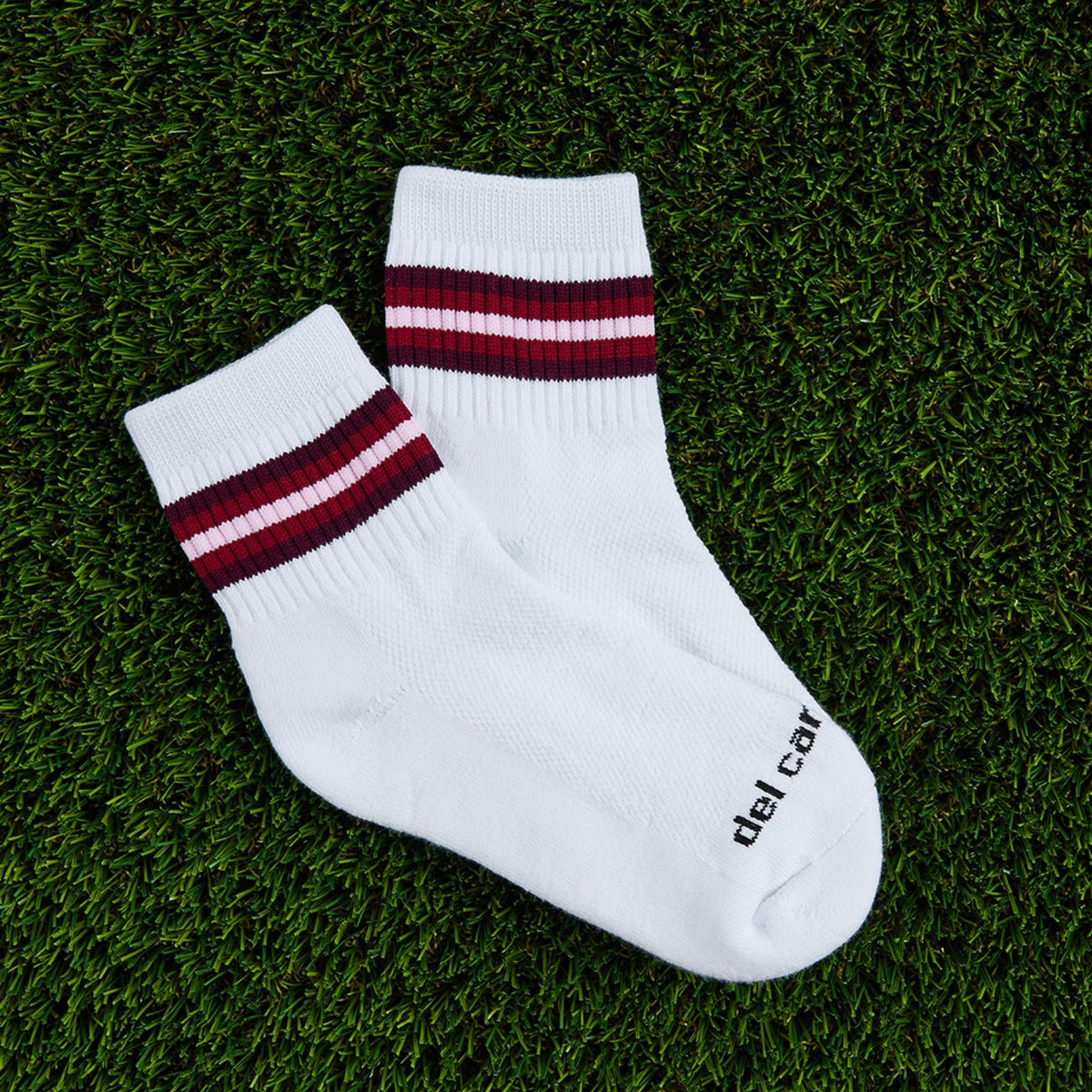 Del Campo Cardinal 5 Stripe golf socks, flat lay on grass