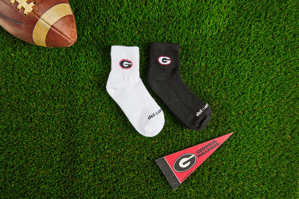 Officially licensed Del Campo Georgia Bulldogs socks laid out on turf.