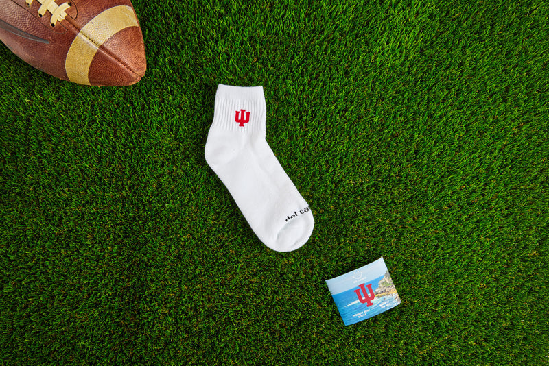 Officially licensed Del Campo Indiana Hoosiers socks laid out on turf.