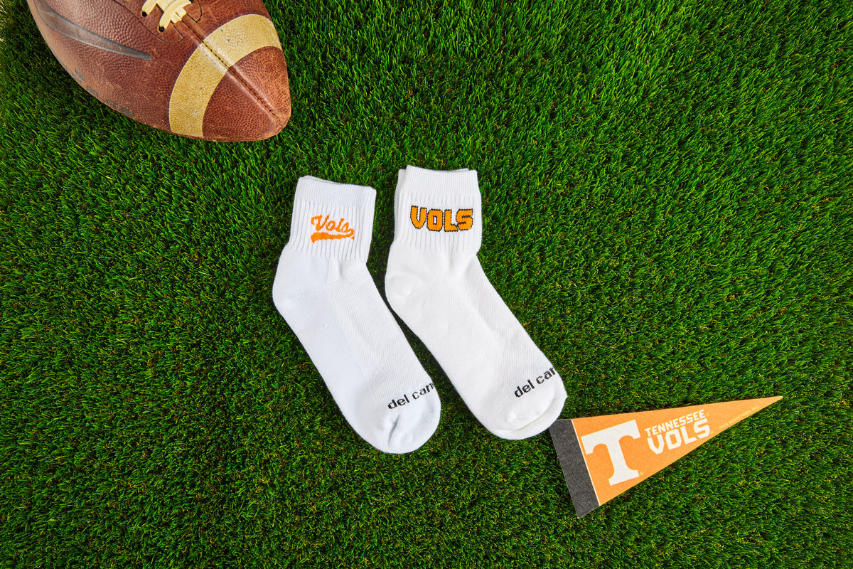 Del Campo Tennessee Volunteers socks on the turf with a Tennessee Volunteers pennant. Made in America.