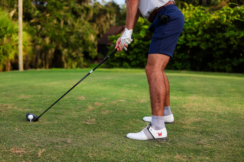 Golfer teeing off in grey Del Campo blank socks