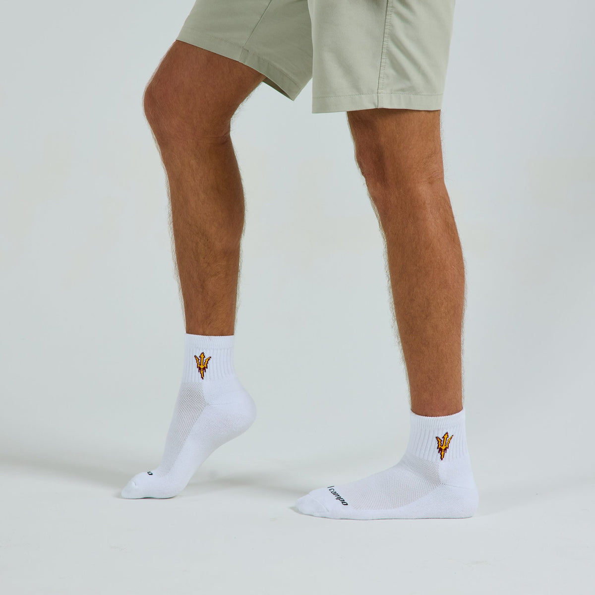 Male model in Del Campo Arizona State Sun Devils golf socks, studio backdrop