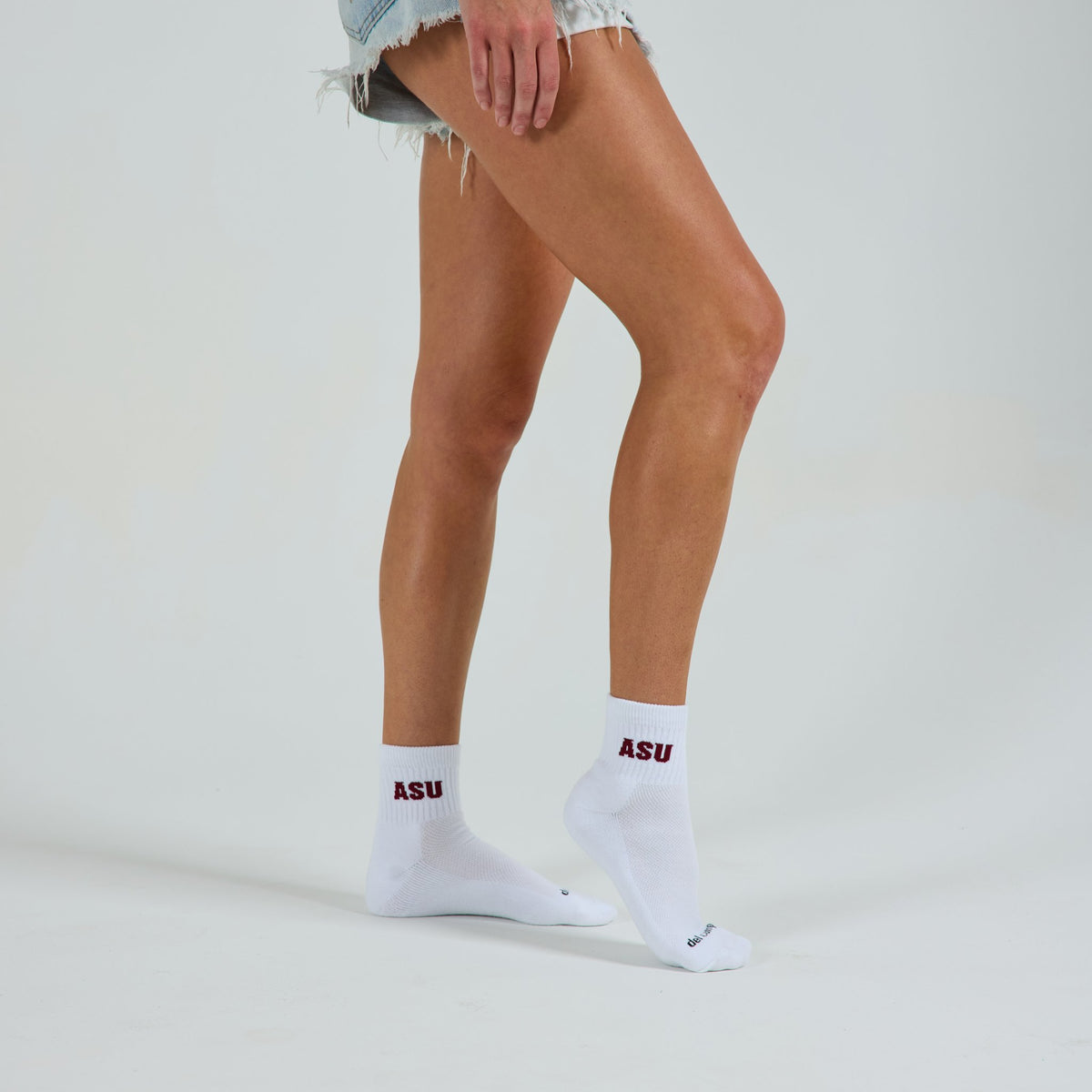 Woman wearing Del Campo Arizona State Sun Devils golf socks, studio shot, no shoes