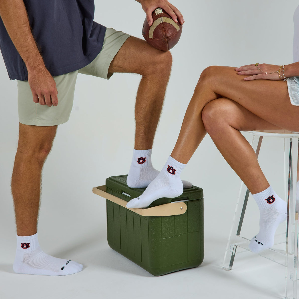 Two models wearing Del Campo Auburn War Eagle golf socks in studio