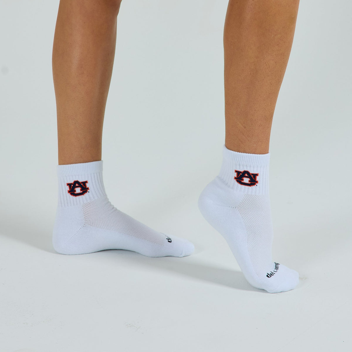 Woman wearing Del Campo Auburn War Eagle golf socks, studio shot, no shoes