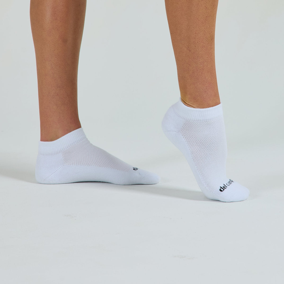 Blank Lowcut Socks worn barefoot, toe wordmark - del campo