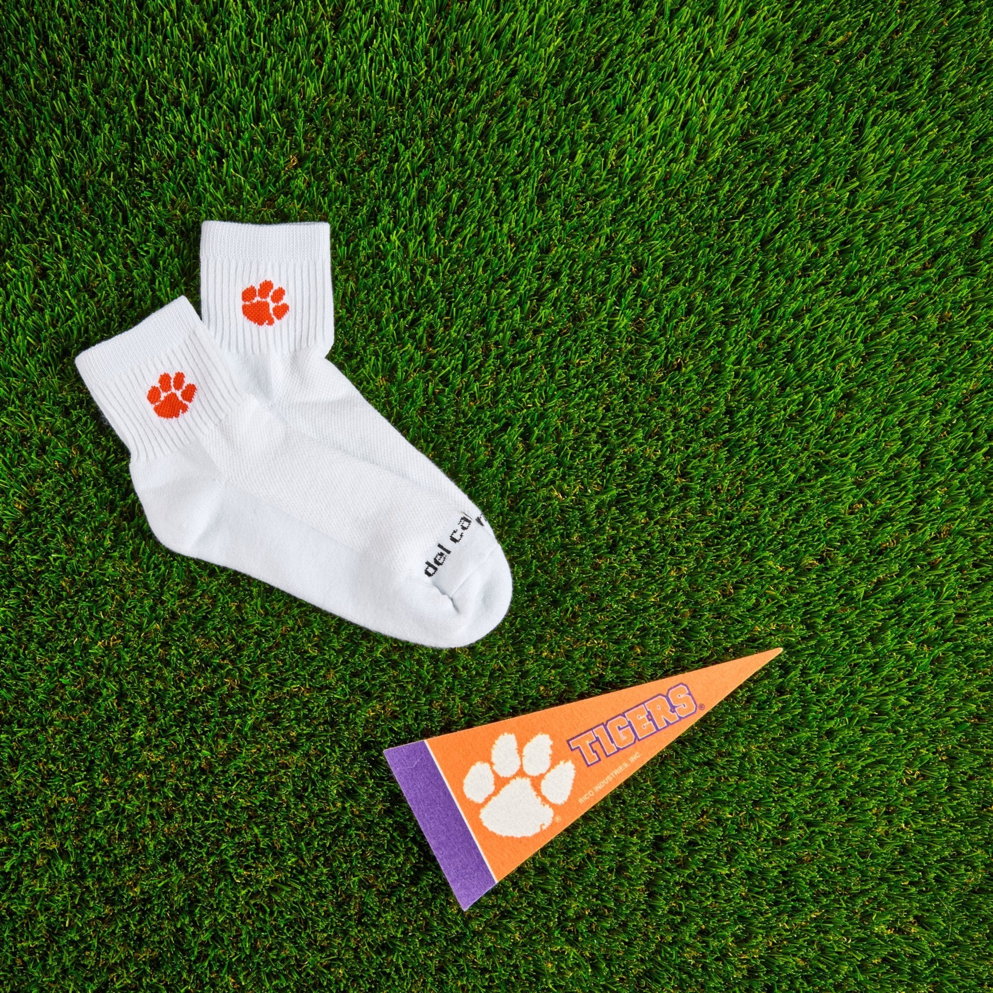 Del Campo Clemson Tigers golf socks on turf with a team pennant