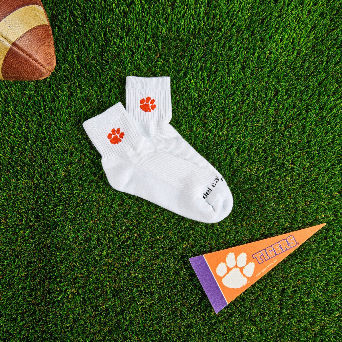 Del Campo Clemson Tigers golf socks on turf with a team pennant