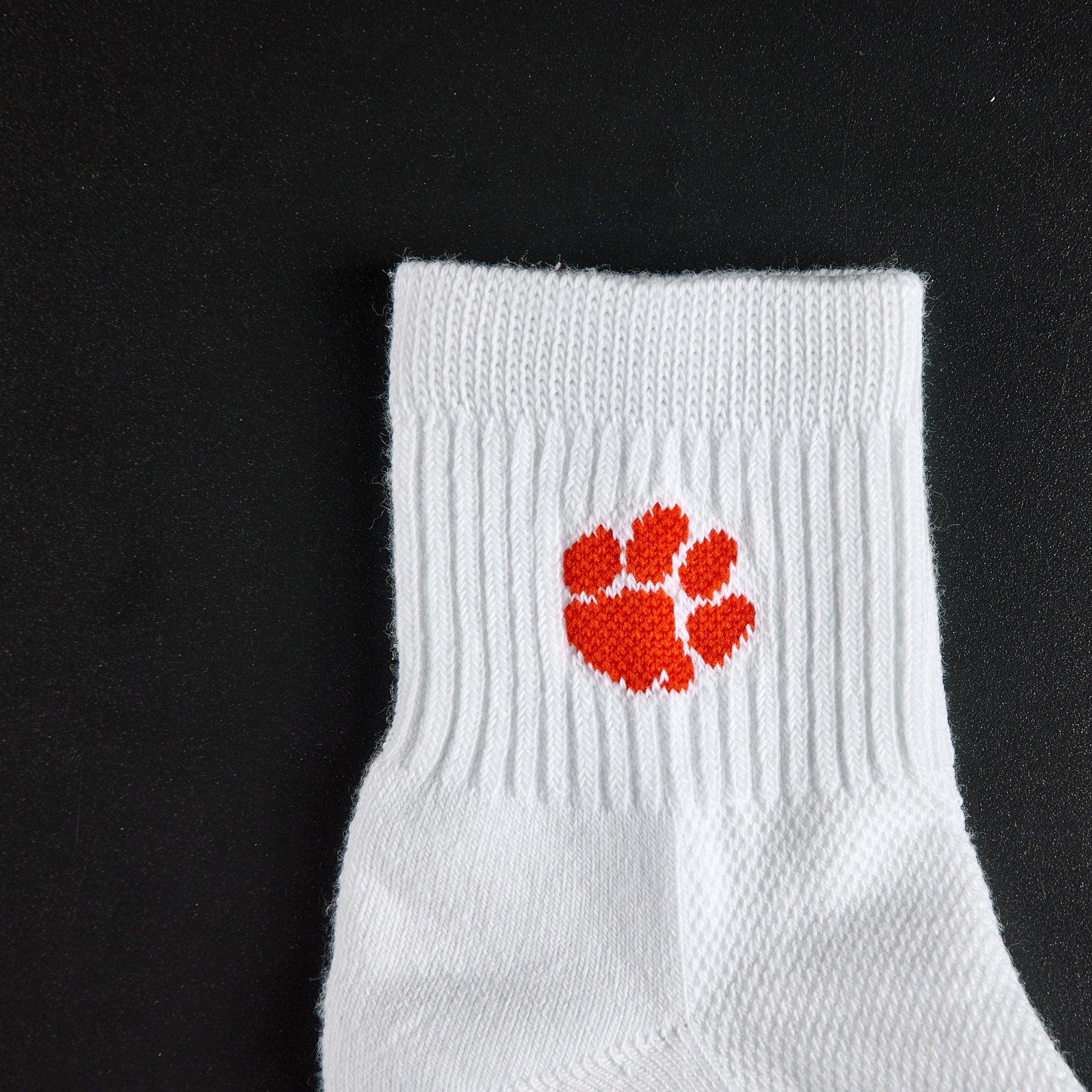 Close-up of the orange tiger paw on Del Campo Clemson Tigers golf socks