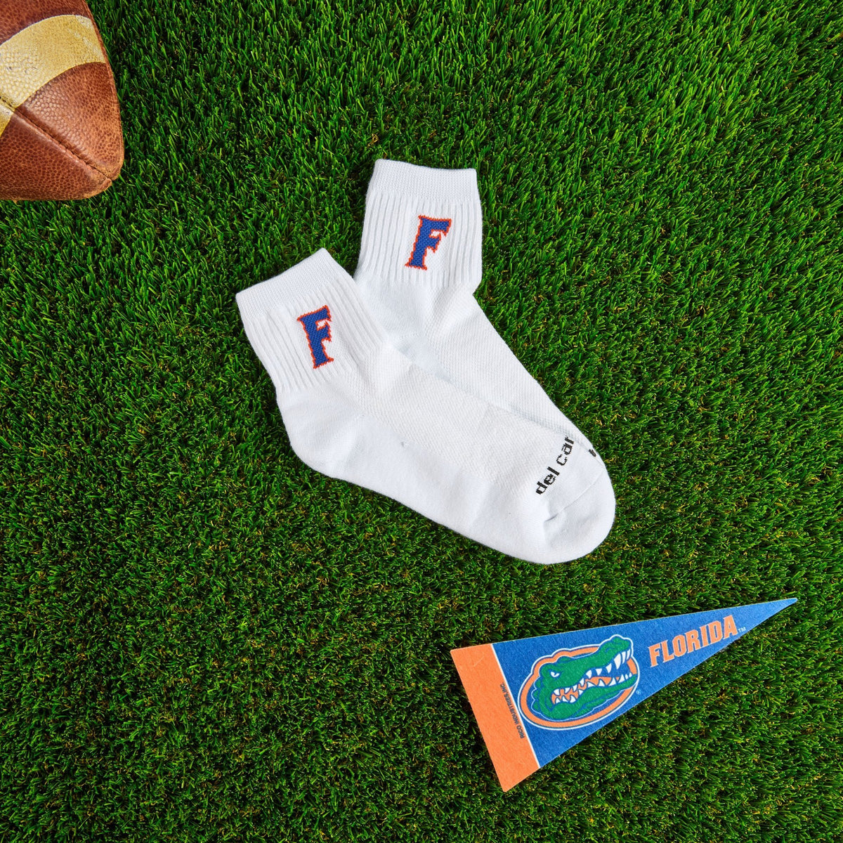 Del Campo Florida Gators Block F golf socks on turf with a team pennant