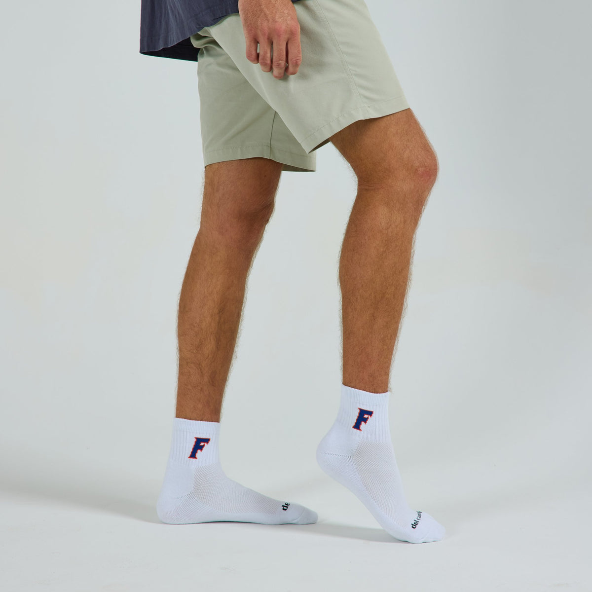 Man wearing Del Campo Florida Gators Block F golf socks, studio shot, no shoes
