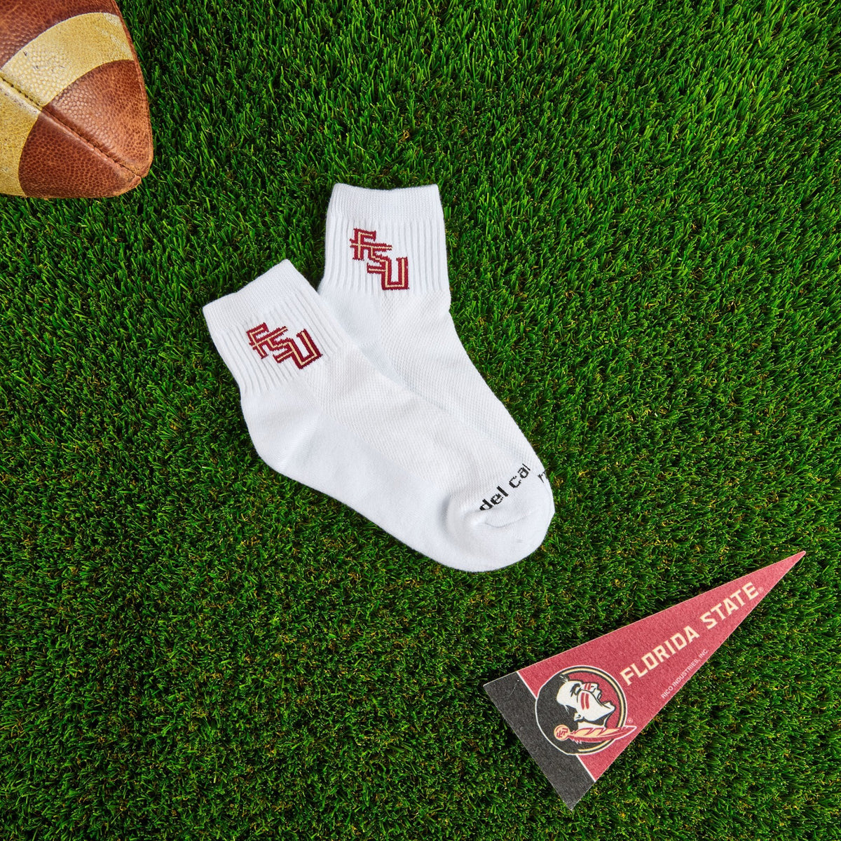 Del Campo Florida State Script golf socks on turf with a team pennant