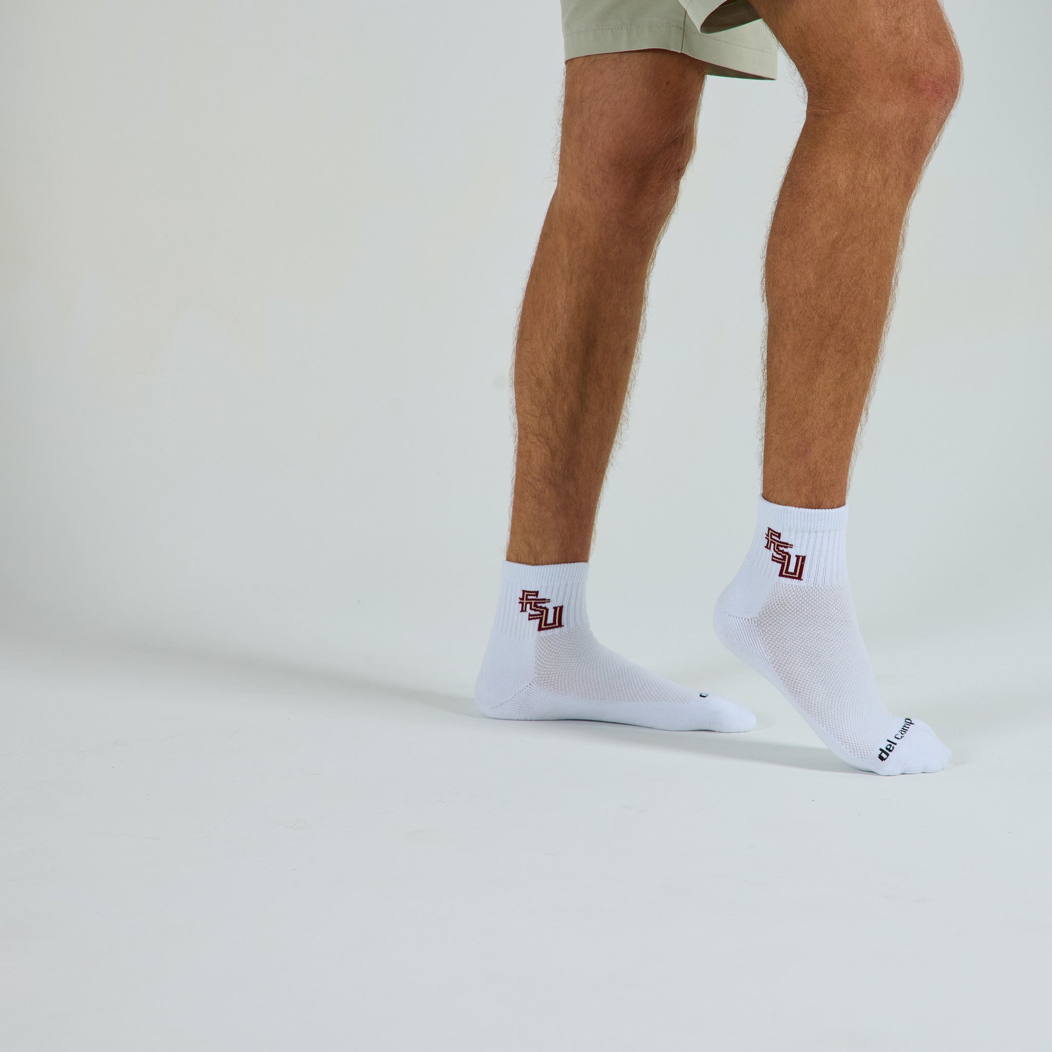 Man wearing Del Campo Florida State Script golf socks, studio shot, no shoes