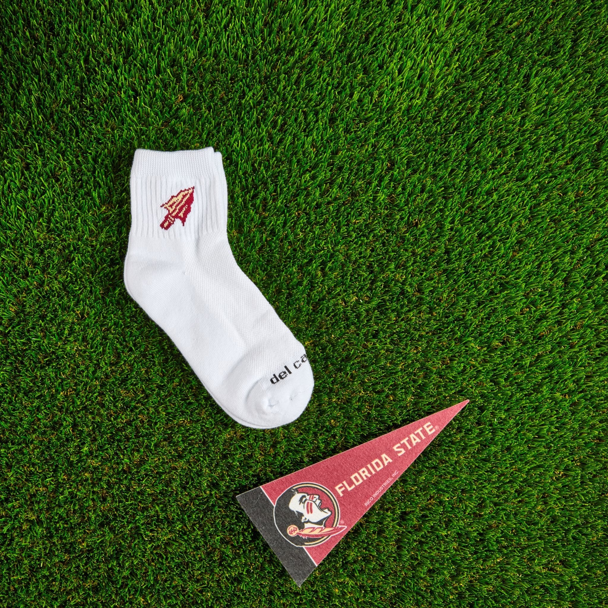 Flat lay of Del Campo Florida State Spear golf socks with game-day props