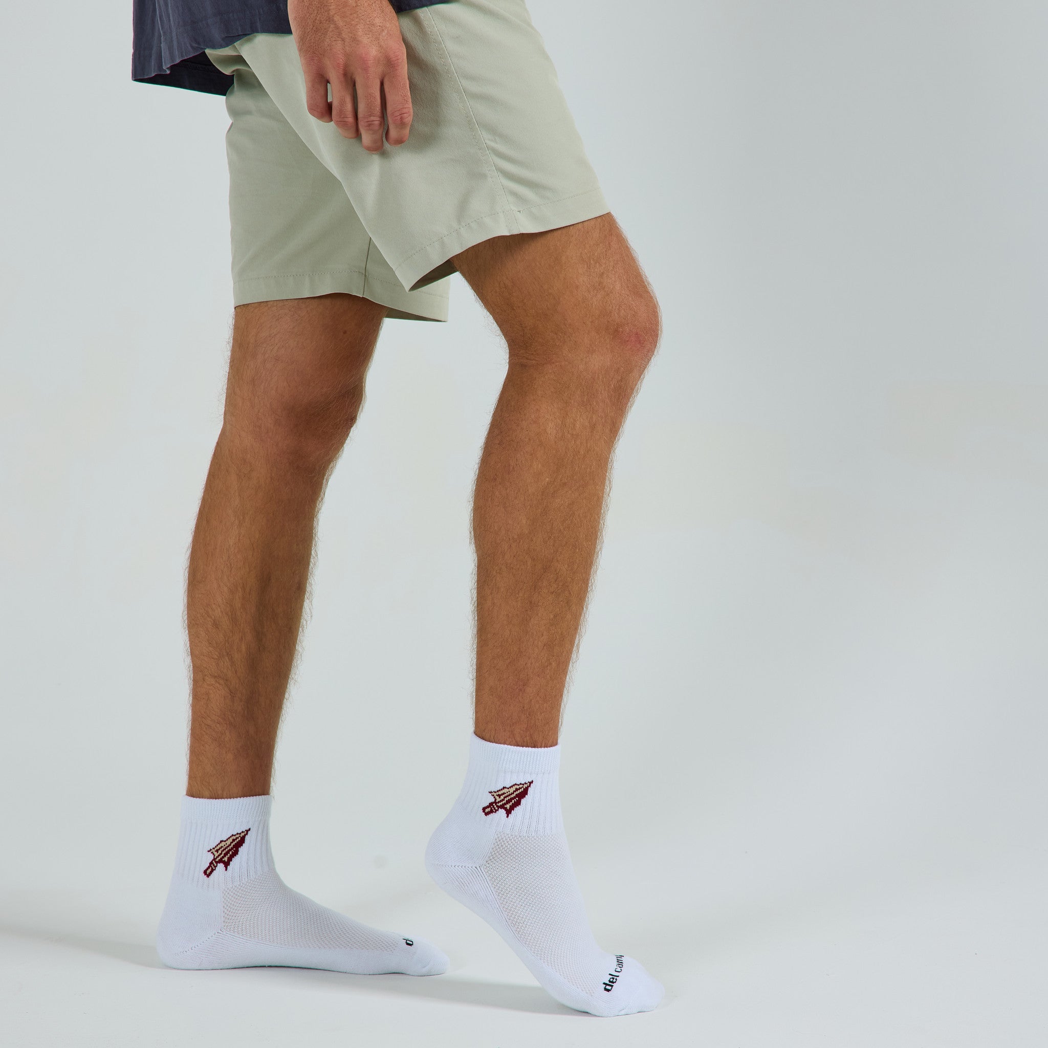 Man wearing Del Campo Florida State Spear golf socks, studio shot, no shoes