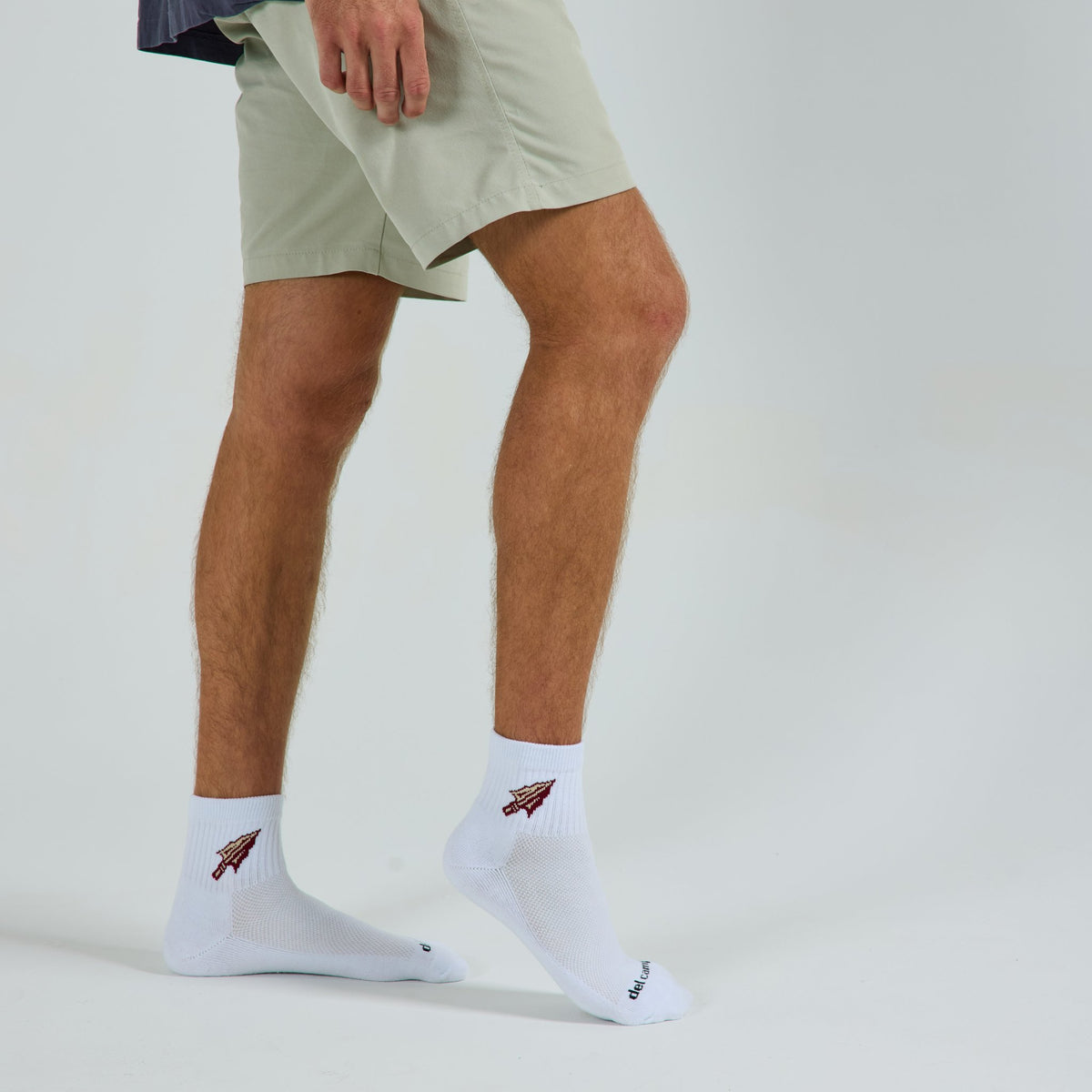 Man wearing Del Campo Florida State Spear golf socks, studio shot, no shoes