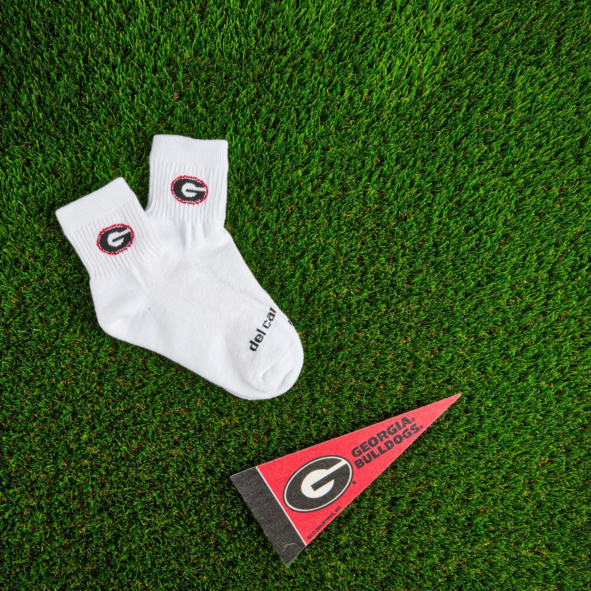 Del Campo Georgia Bulldogs golf socks on turf with a team pennant