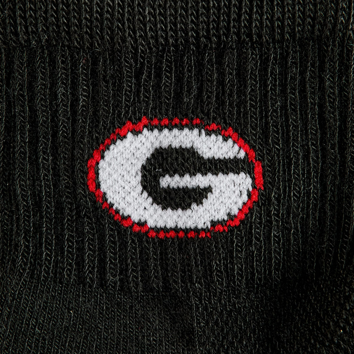 Close-up of the G on Del Campo Georgia Night Mode golf socks