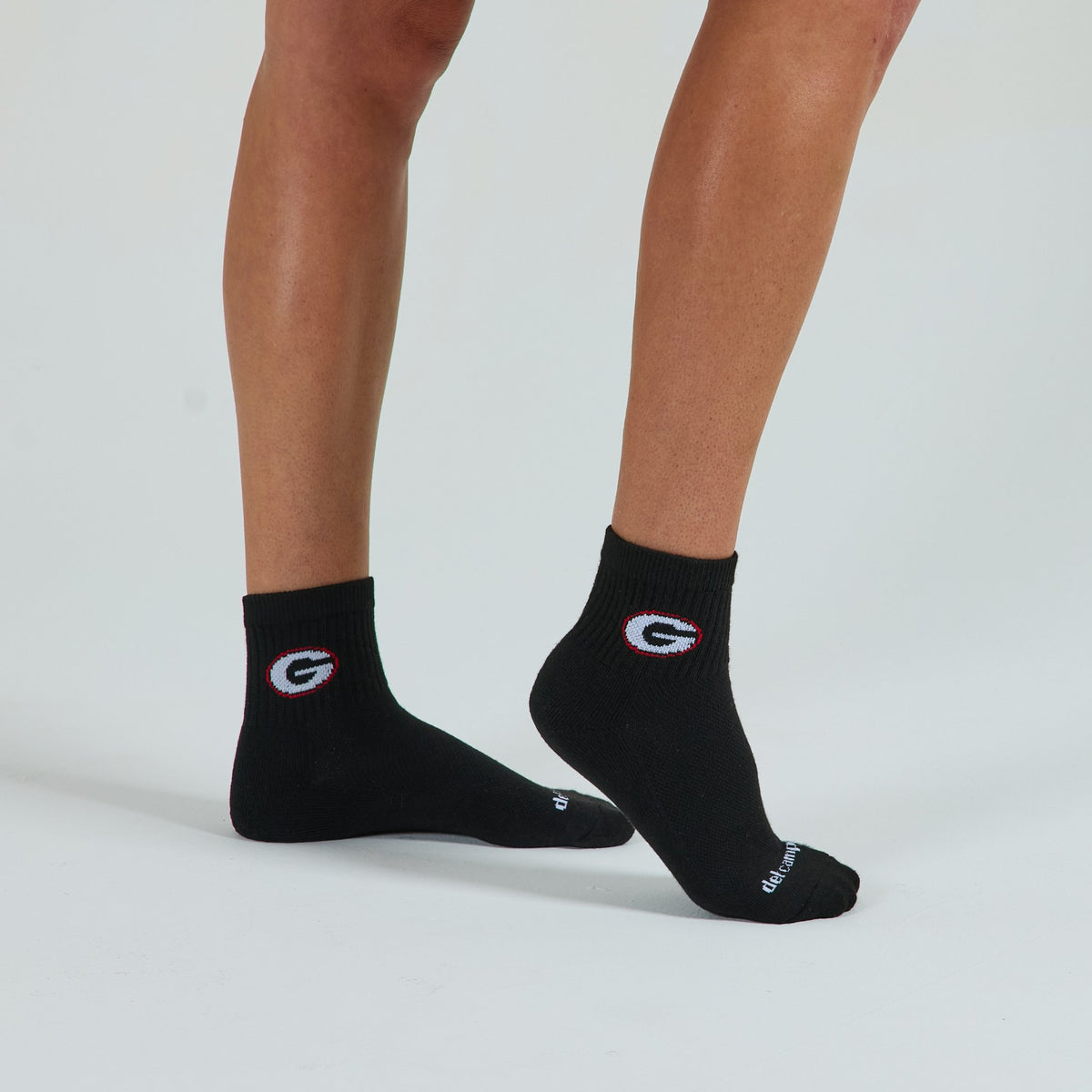 Woman wearing Del Campo Georgia Night Mode golf socks, studio shot, no shoes