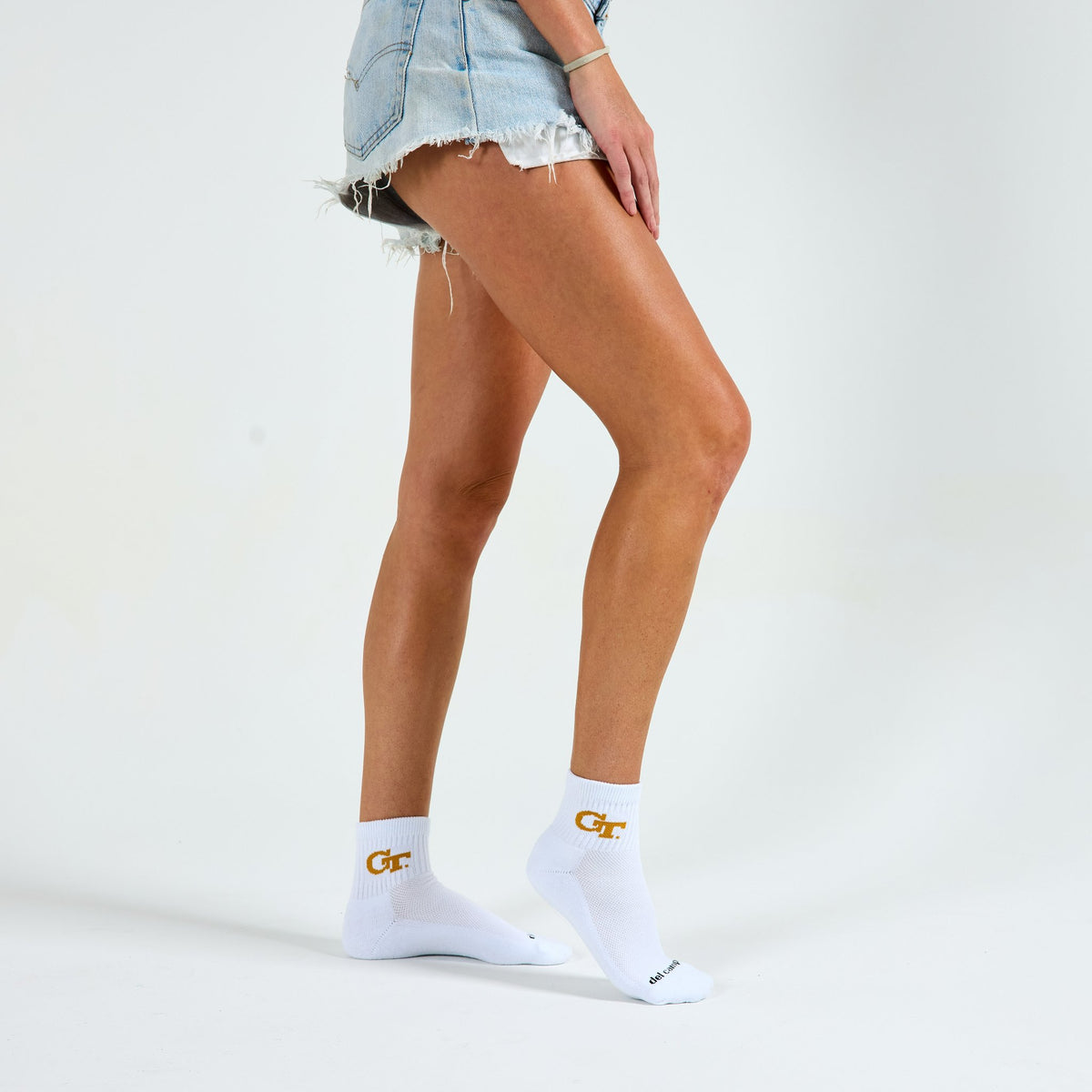 Woman wearing Del Campo Georgia Tech GT golf socks, studio shot, no shoes