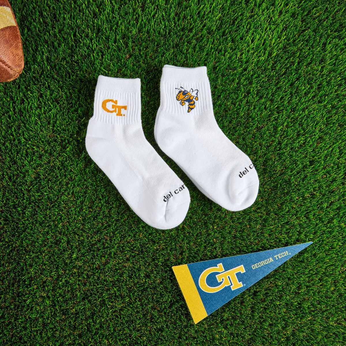 Del Campo Georgia Tech Pack golf socks on turf with a team pennant