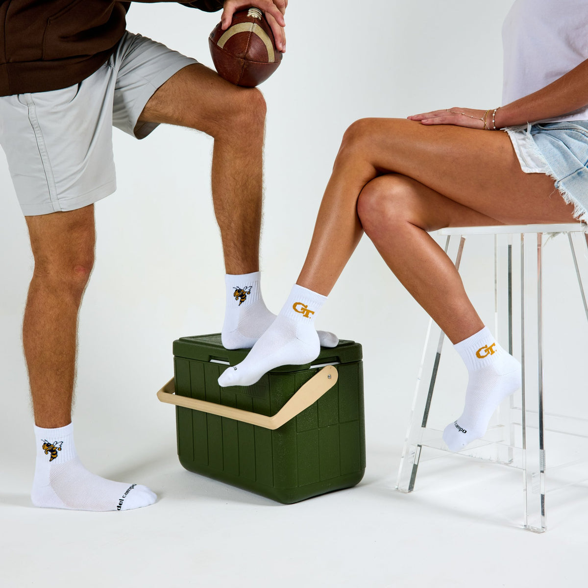 Two models wearing Del Campo Georgia Tech Pack golf socks in studio