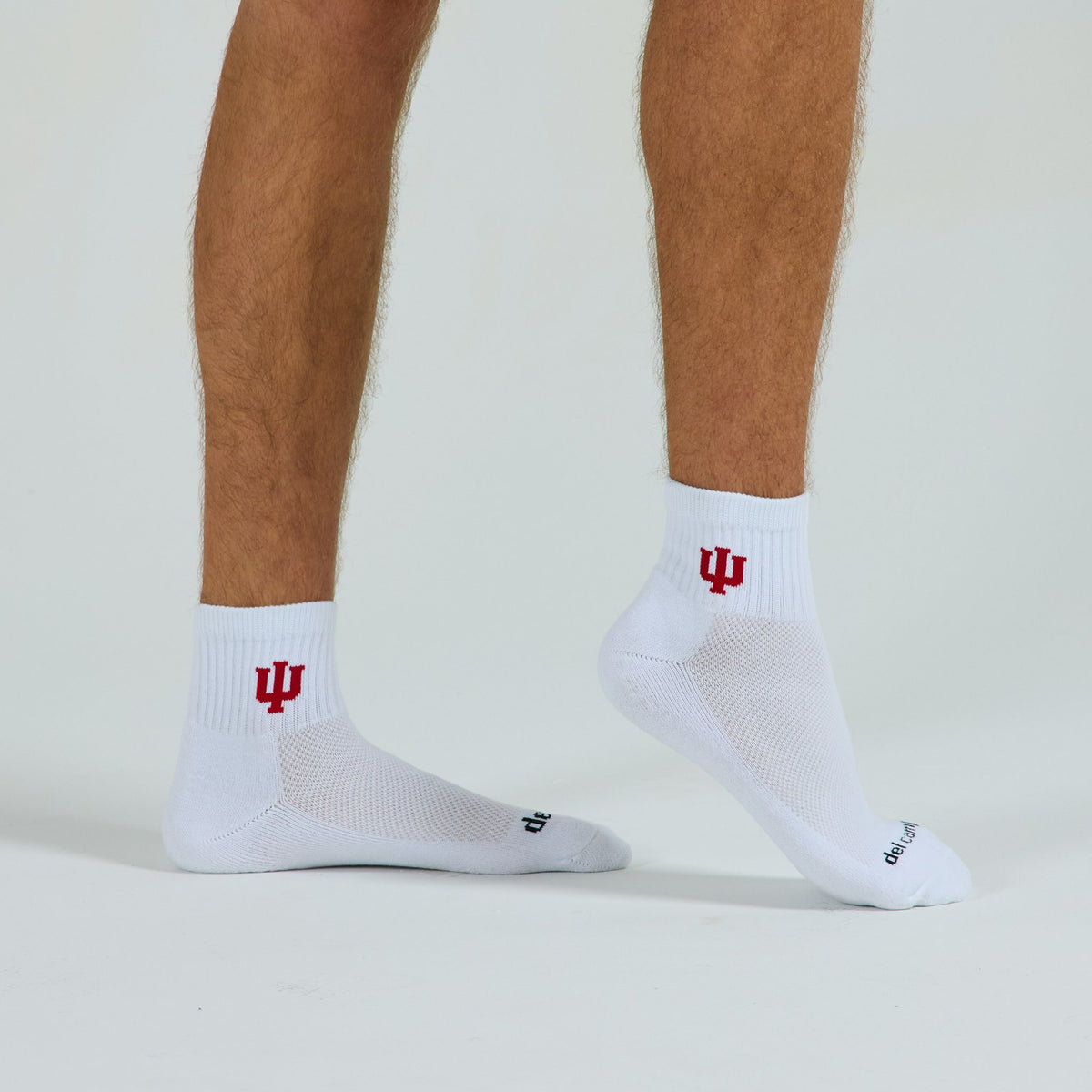 Male model in Del Campo Indiana Hoosiers golf socks, studio backdrop