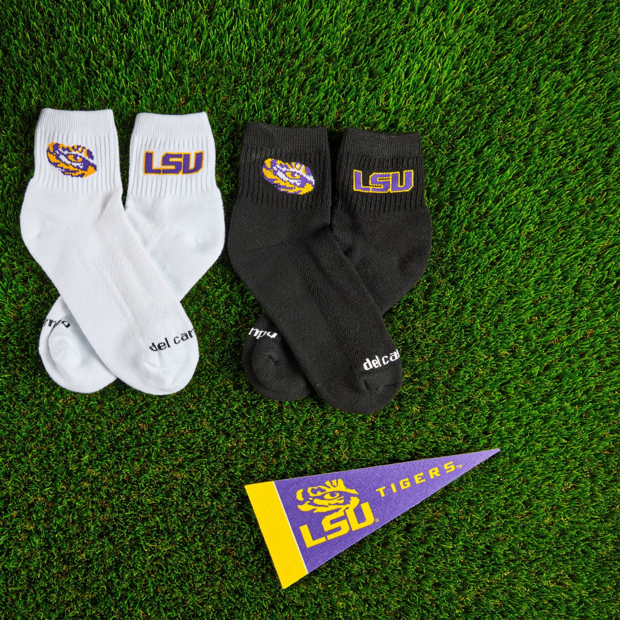 Del Campo LSU Tigers golf socks on turf, white and black colourways together