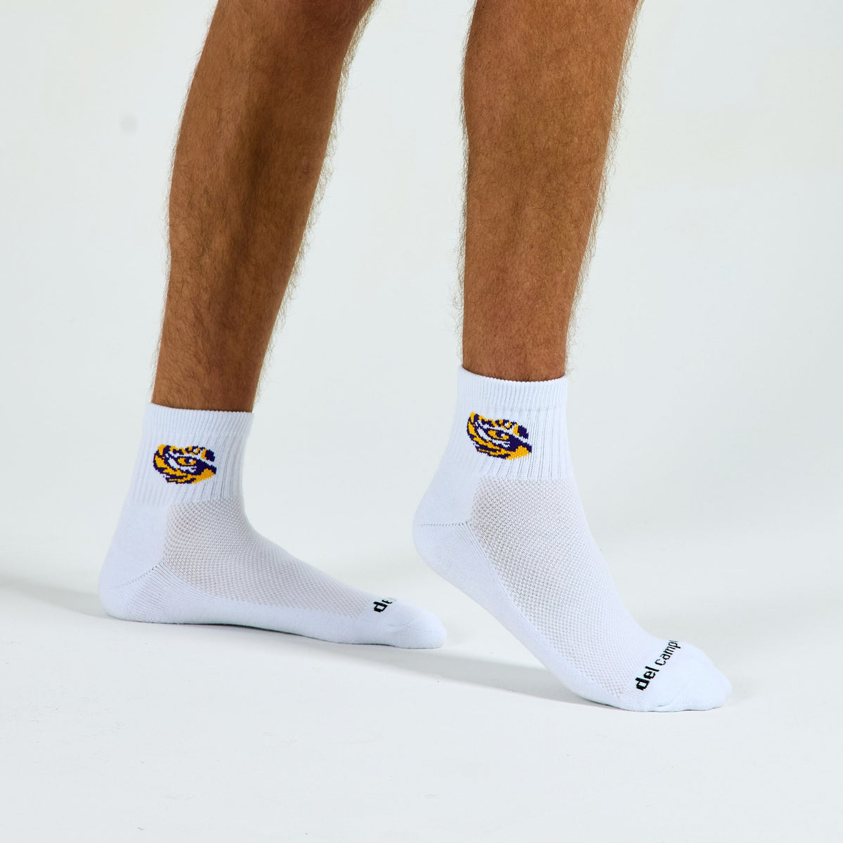 Man wearing Del Campo LSU Tigers golf socks, studio shot, no shoes