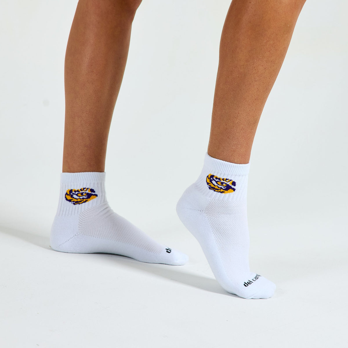 Woman wearing Del Campo LSU Tigers golf socks, studio shot, no shoes