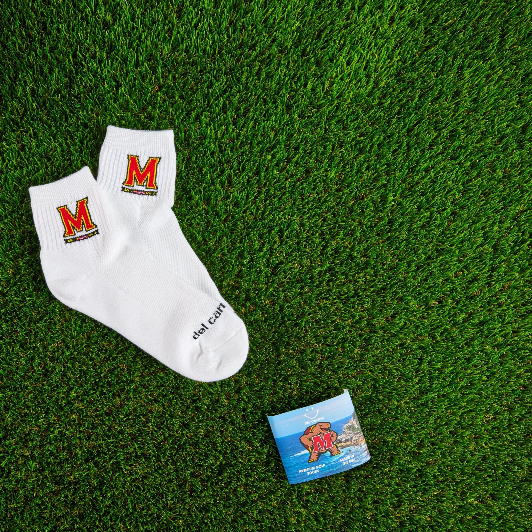 Del Campo Maryland Terrapins golf socks on turf with a team pennant