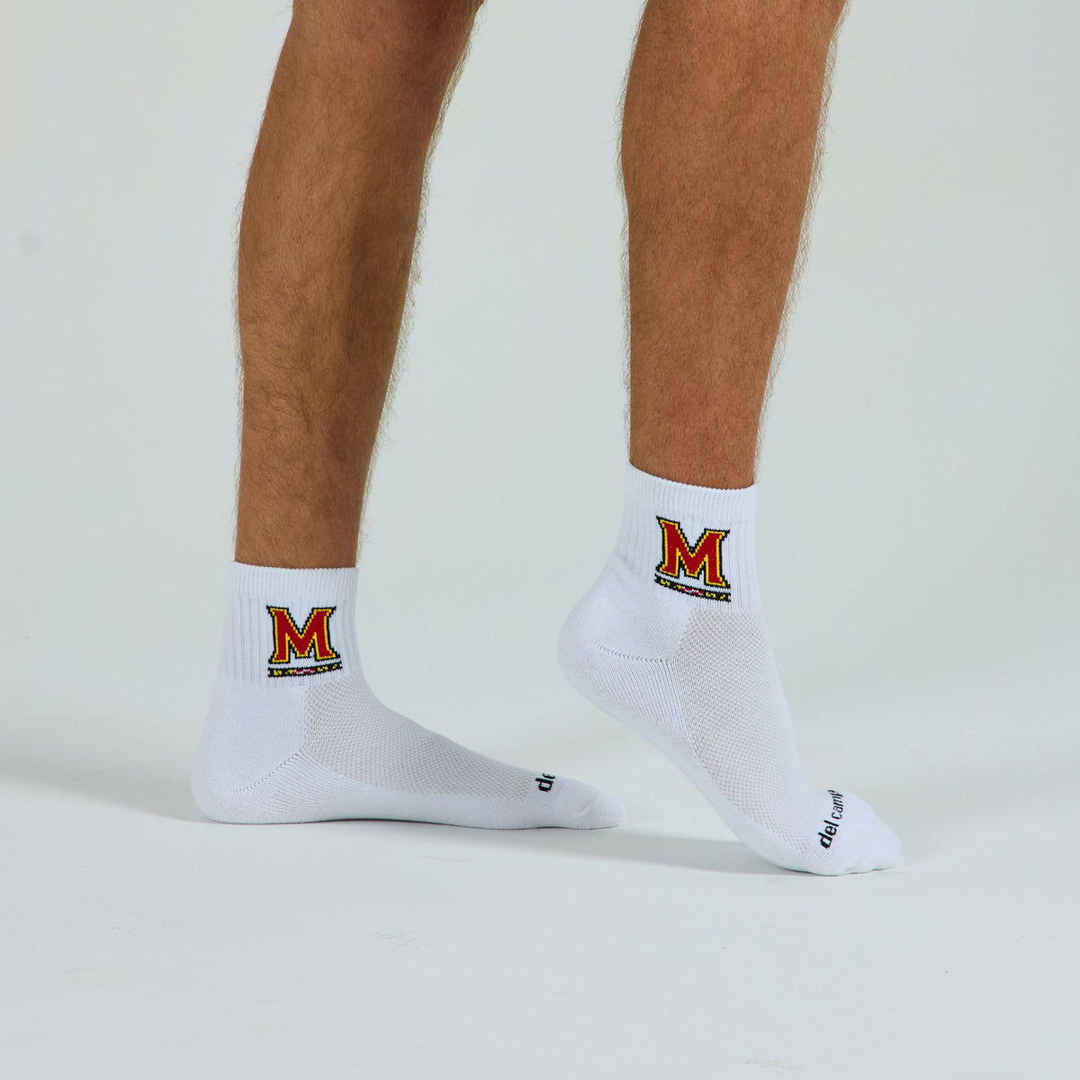 Man wearing Del Campo Maryland Terrapins golf socks, studio shot, no shoes