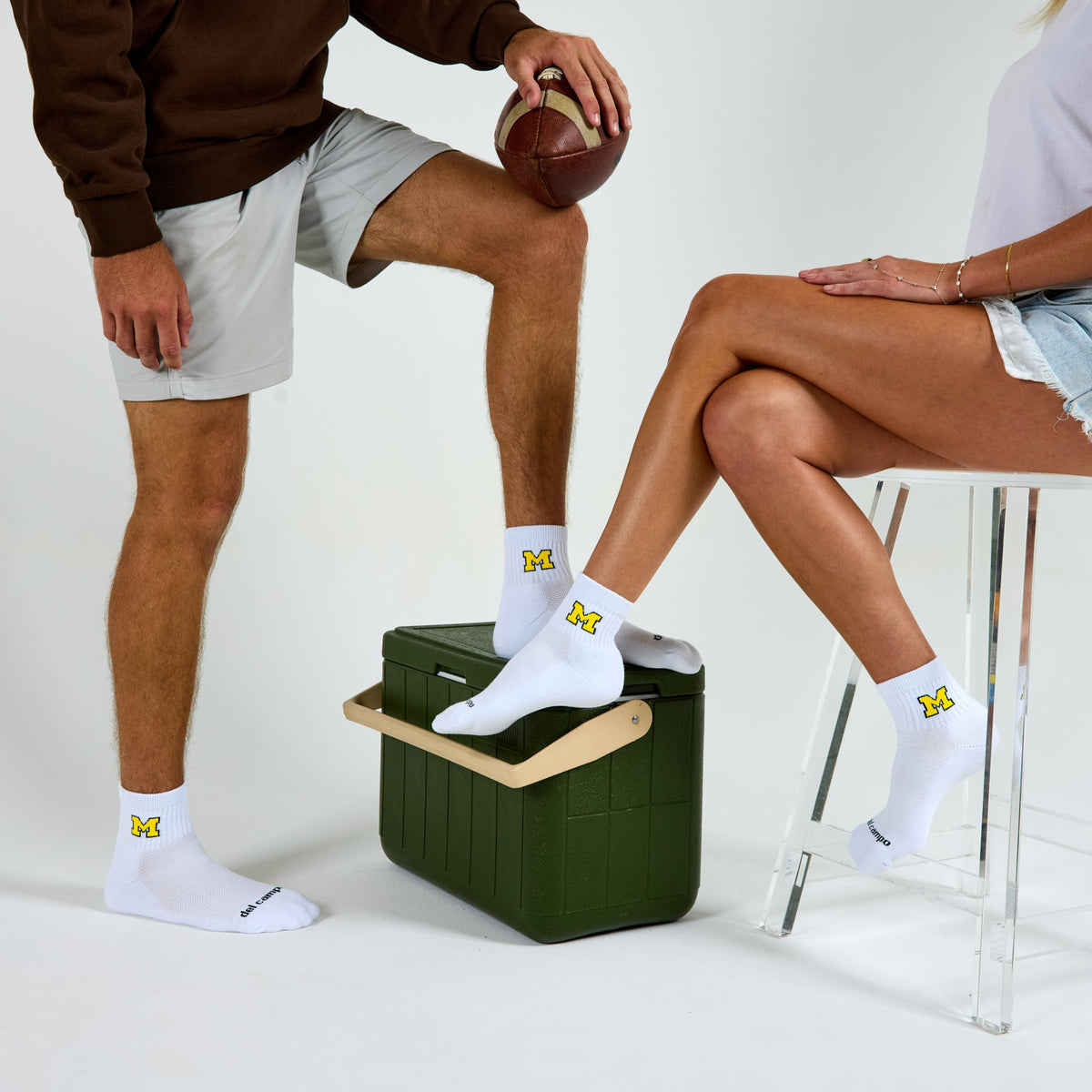 Two models wearing Del Campo Michigan Maize golf socks in studio