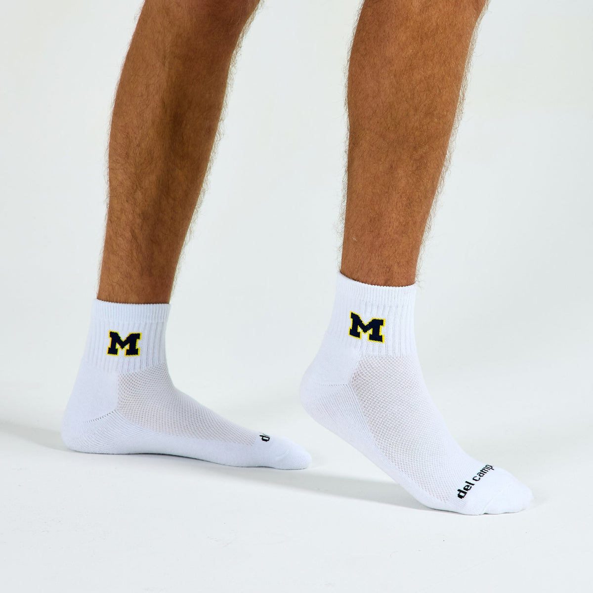 Man wearing Del Campo Michigan Wolverines Navy golf socks, studio shot