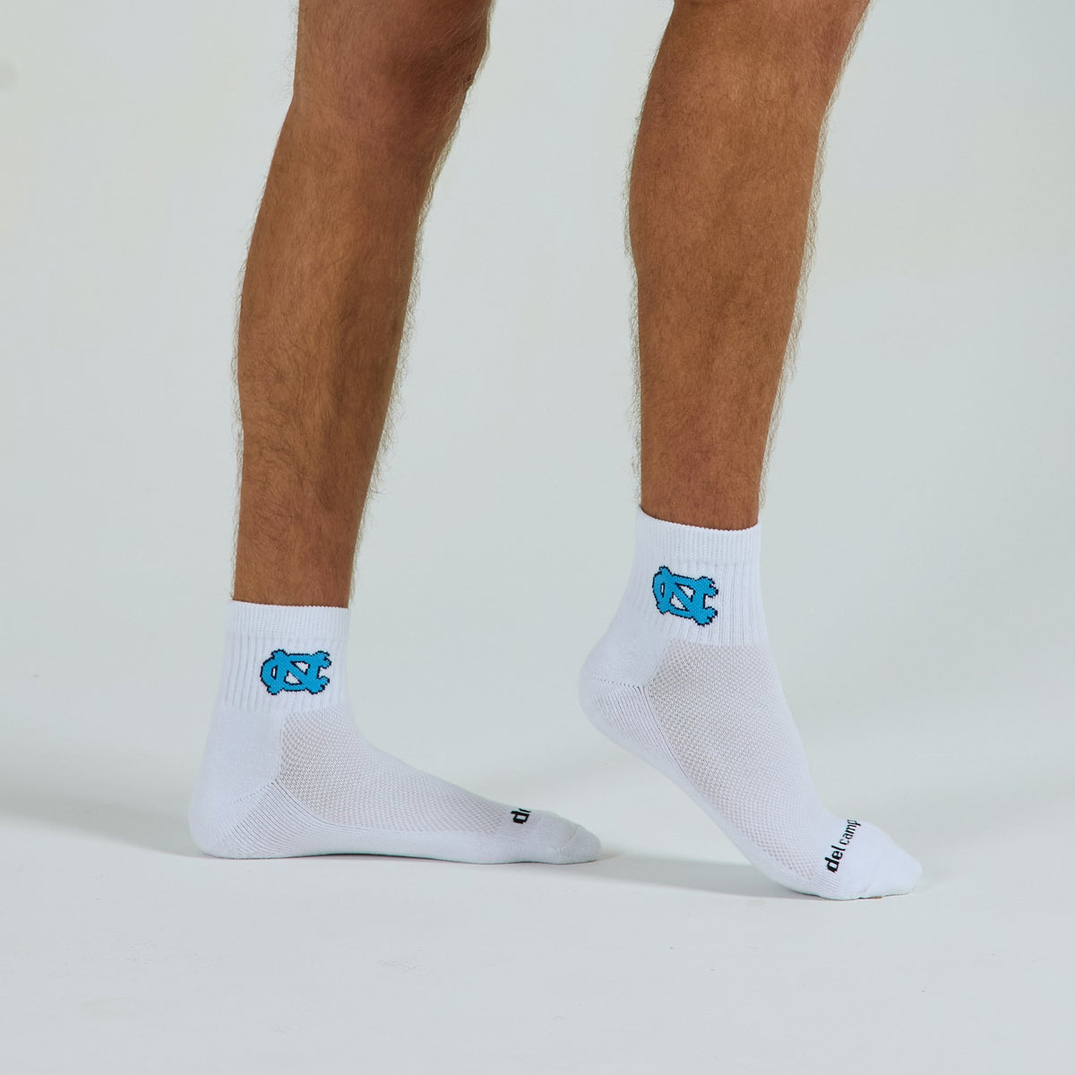 Del Campo North Carolina Interlocking NC golf socks on a male model in studio