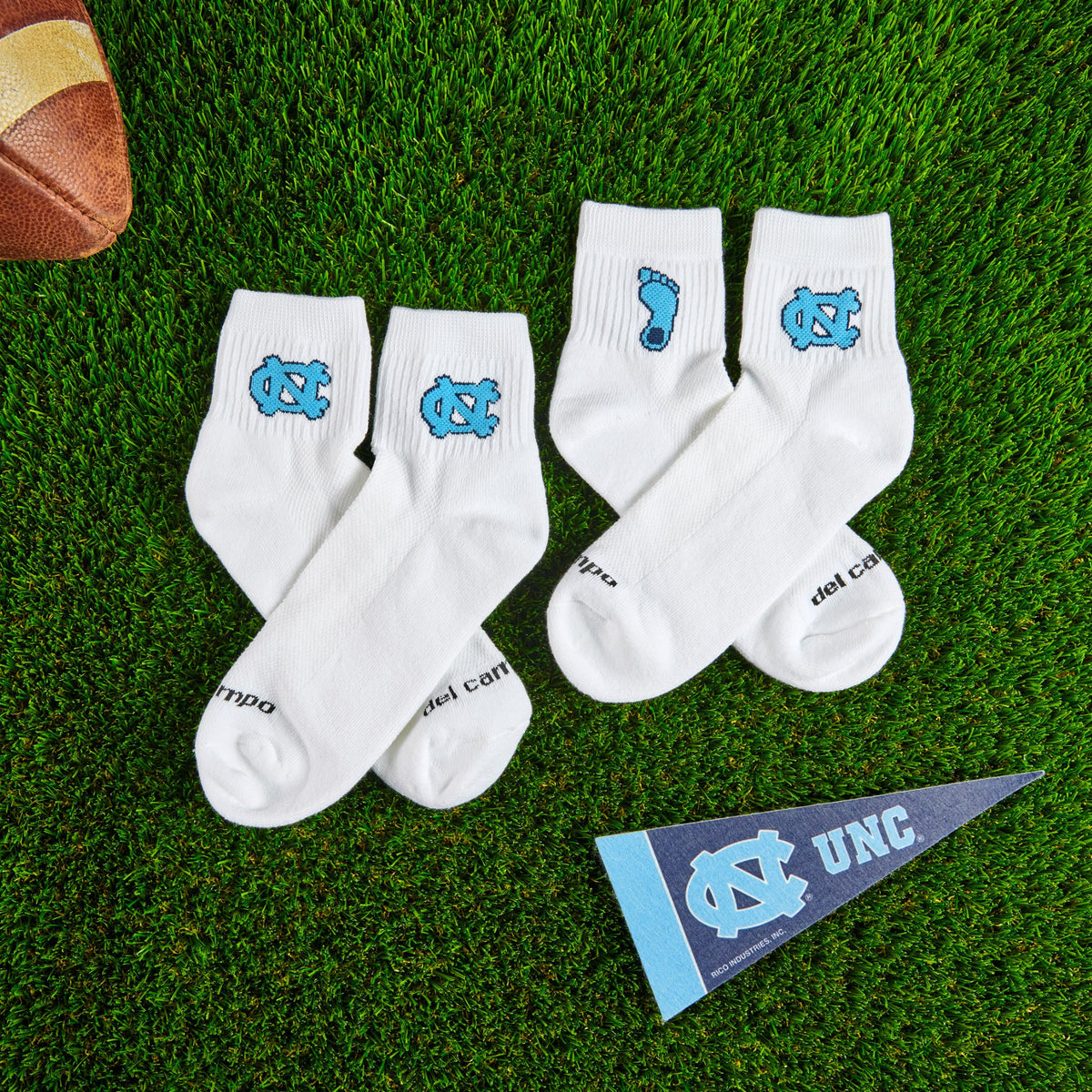 Del Campo North Carolina Pack golf socks on turf with a team pennant