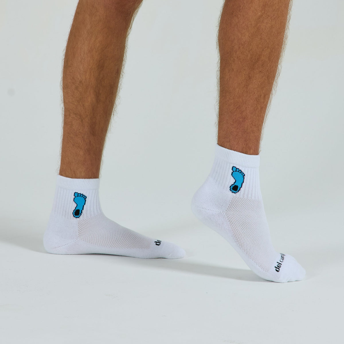 Man wearing Del Campo North Carolina Tar Heel golf socks, studio shot, no shoes