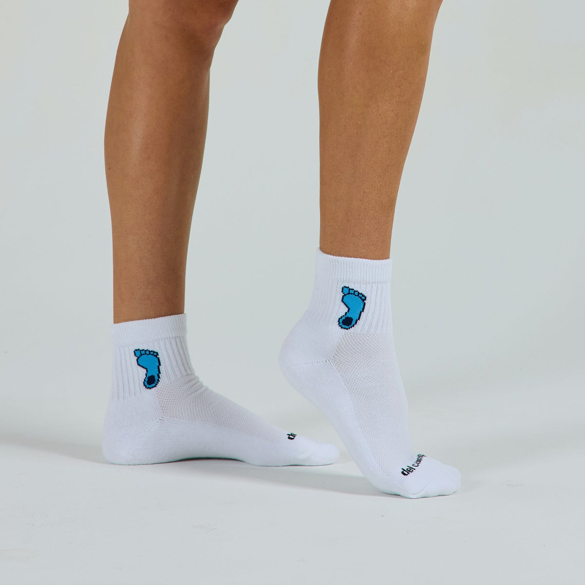 Woman wearing Del Campo North Carolina Tar Heel golf socks, studio shot, no shoes