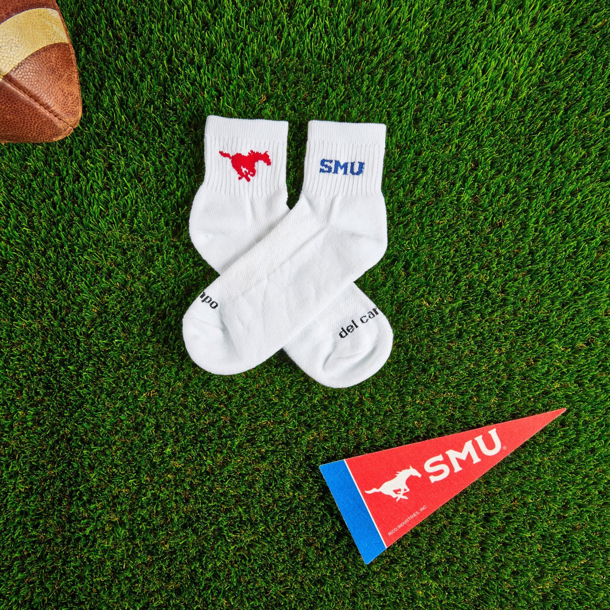 Del Campo SMU Mustangs golf socks on turf with a team pennant
