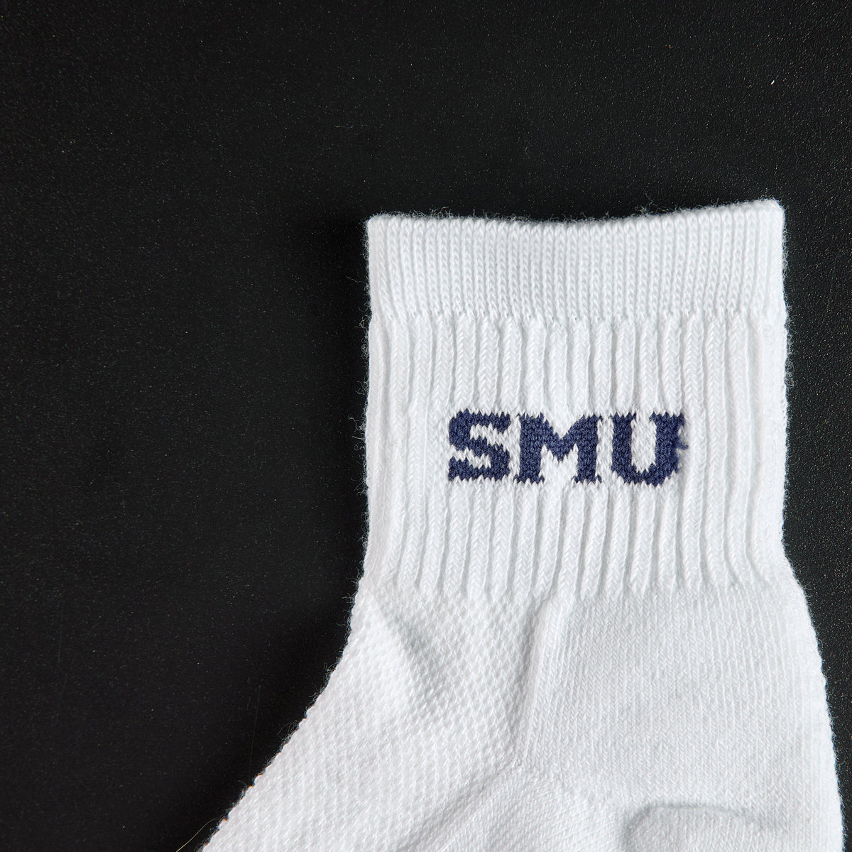 Close-up of the navy SMU wordmark on Del Campo SMU Mustangs golf socks