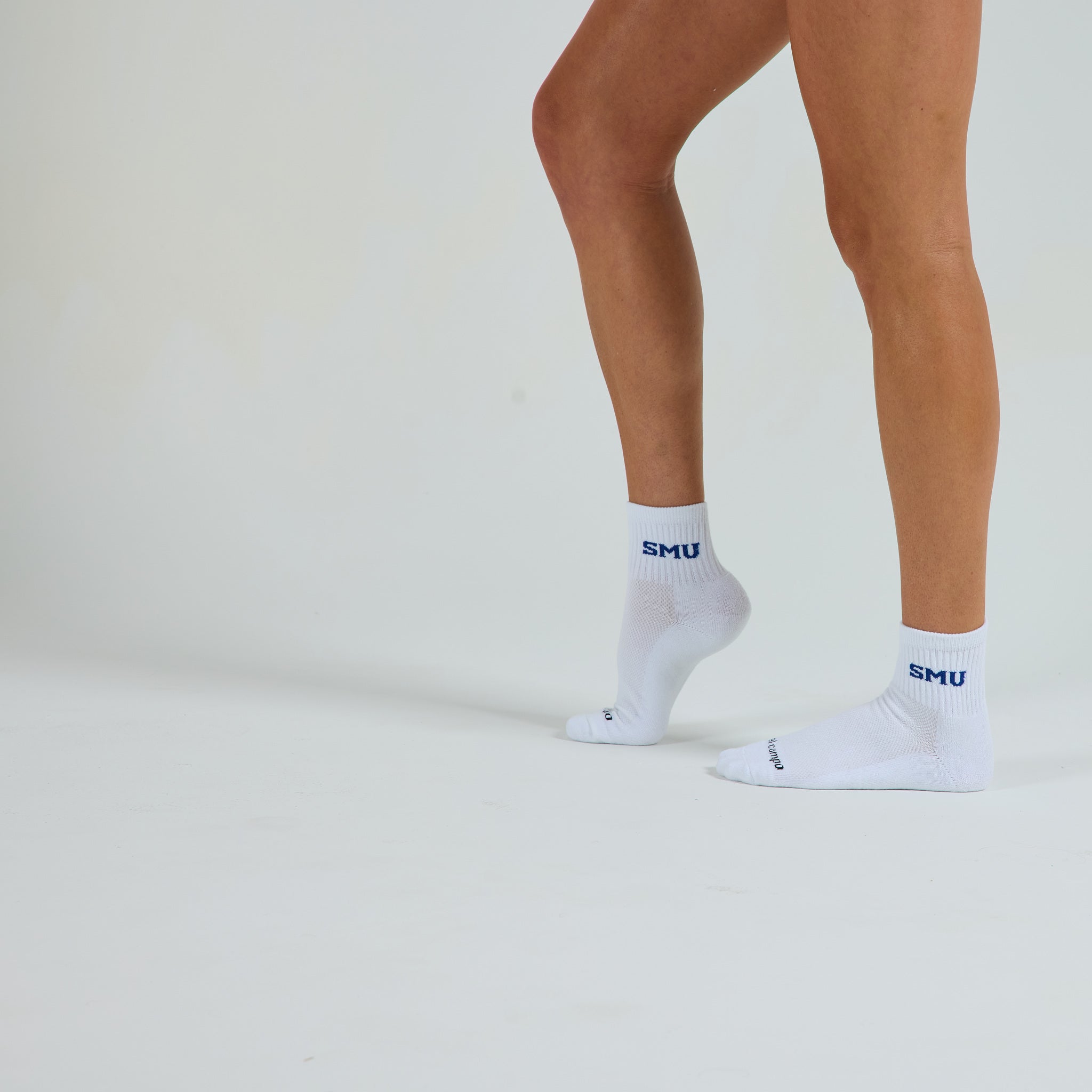 Man wearing Del Campo SMU Mustangs golf socks, studio shot, no shoes