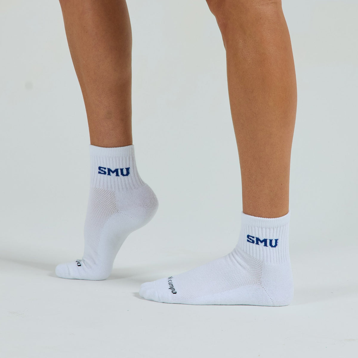 Man wearing Del Campo SMU Mustangs golf socks, studio shot, no shoes