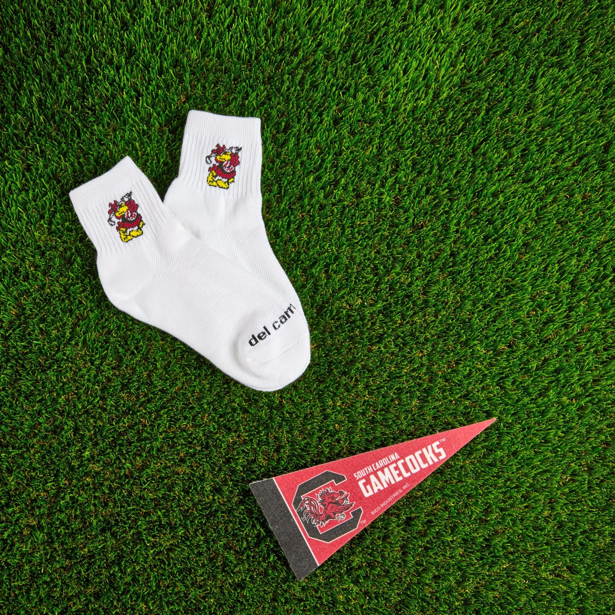 Del Campo South Carolina Cocky golf socks on turf with a team pennant