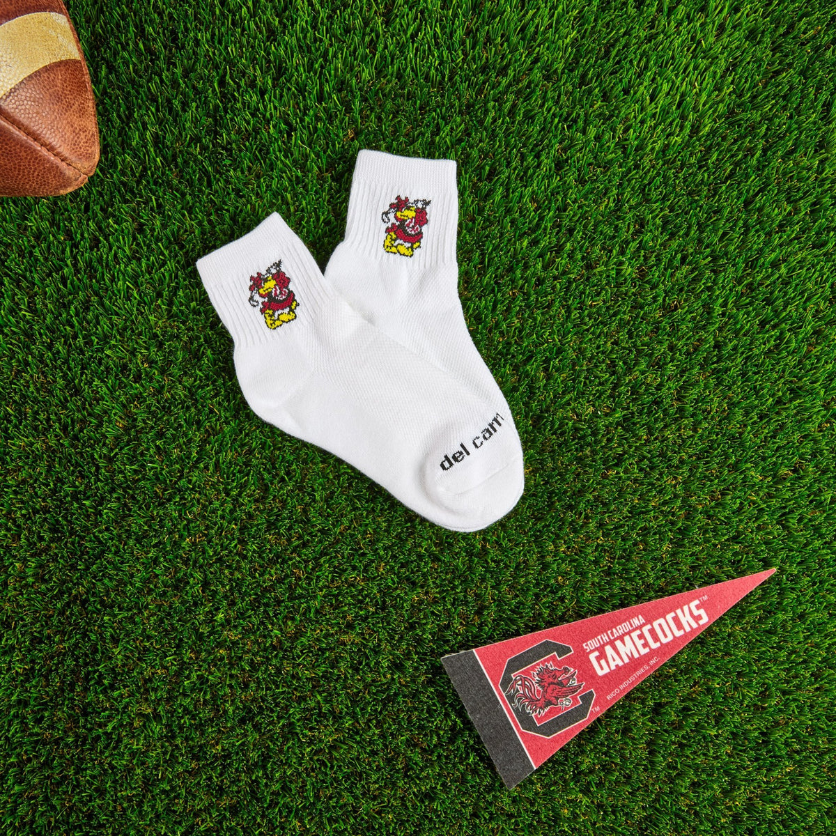 Del Campo South Carolina Cocky golf socks on turf with a team pennant