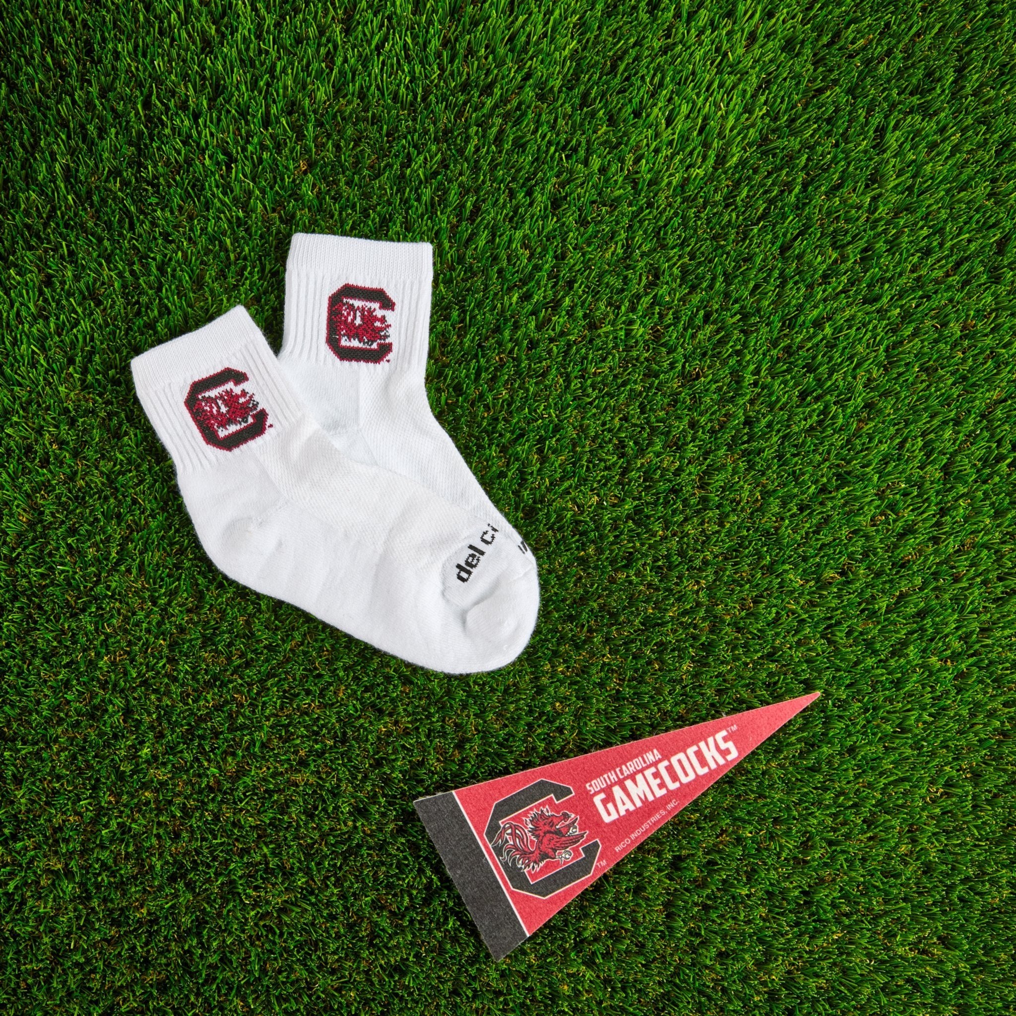 Del Campo South Carolina Gamecocks golf socks on turf with a team pennant