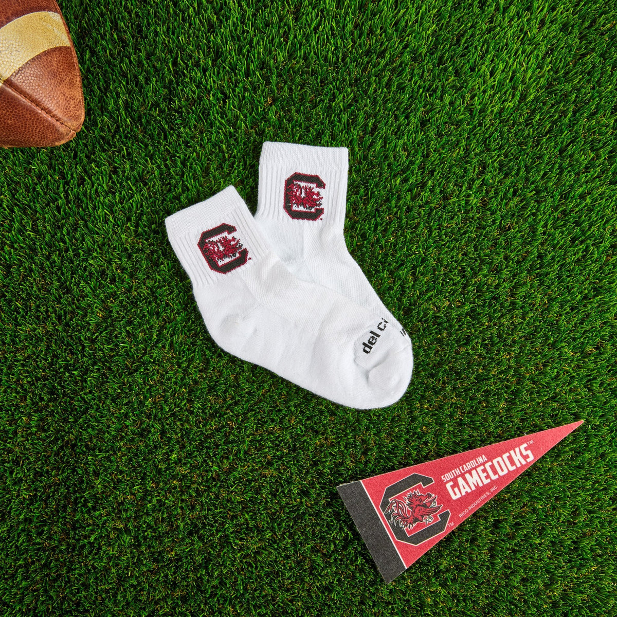 Del Campo South Carolina Gamecocks golf socks on turf with a team pennant