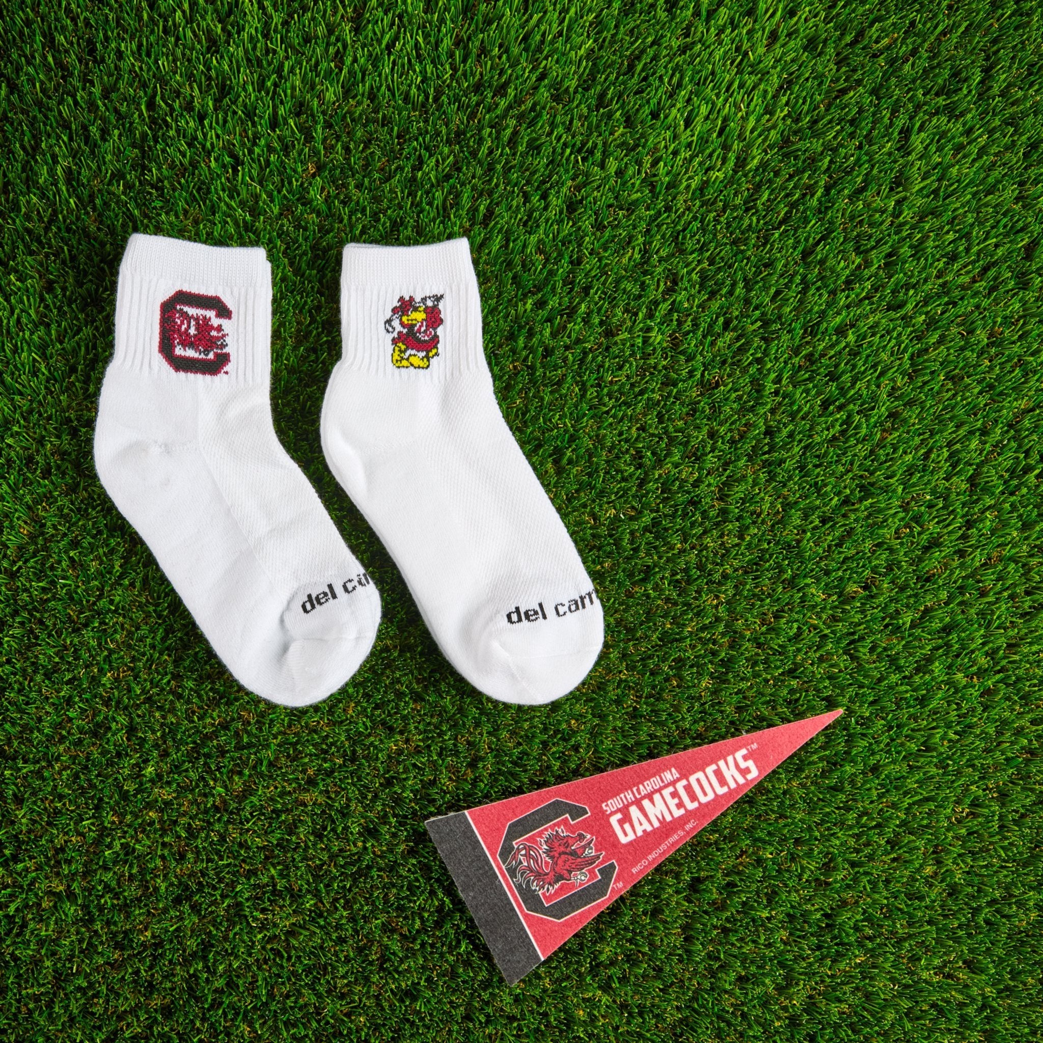 Del Campo South Carolina Pack golf socks on turf with a team pennant
