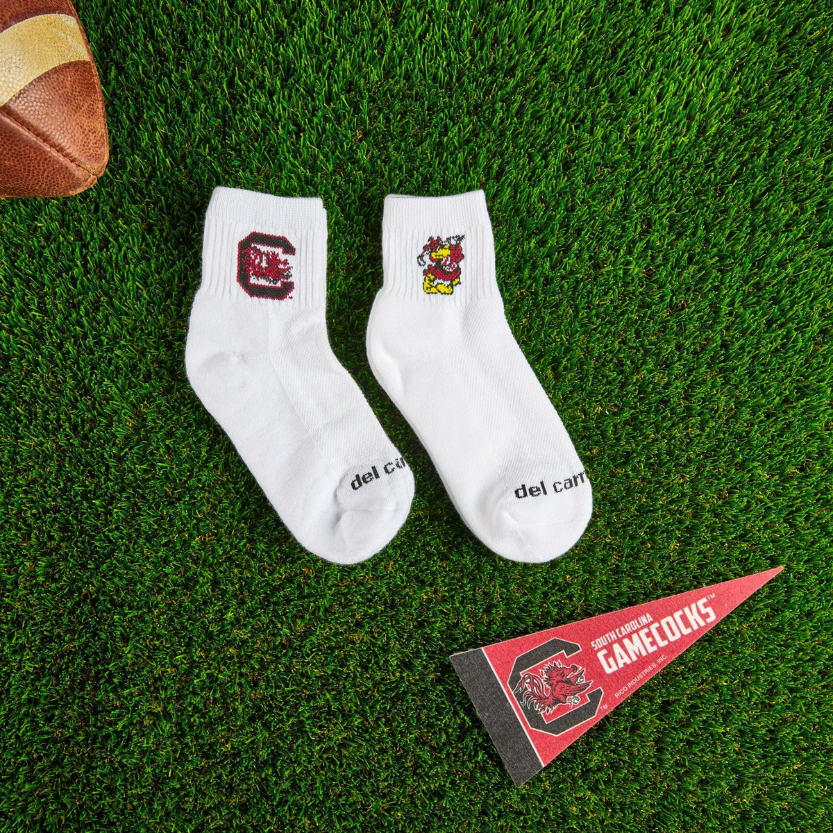 Del Campo South Carolina Pack golf socks on turf with a team pennant