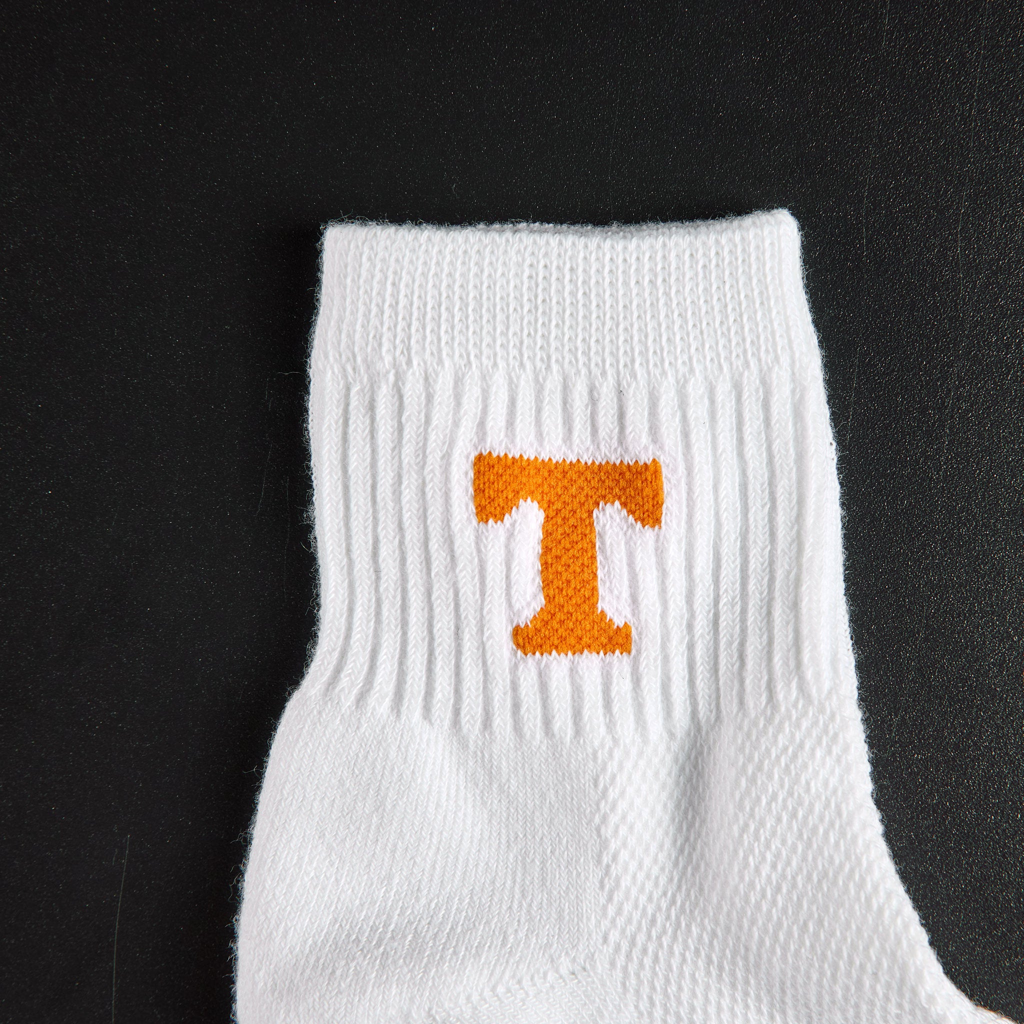 Close-up of the orange Power T on Del Campo Tennessee Block T golf socks