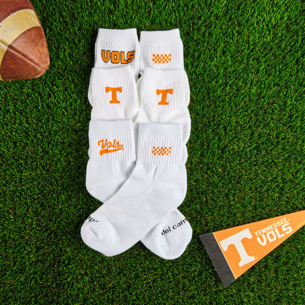 Flat lay of Del Campo Tennessee Pack golf socks with game-day props